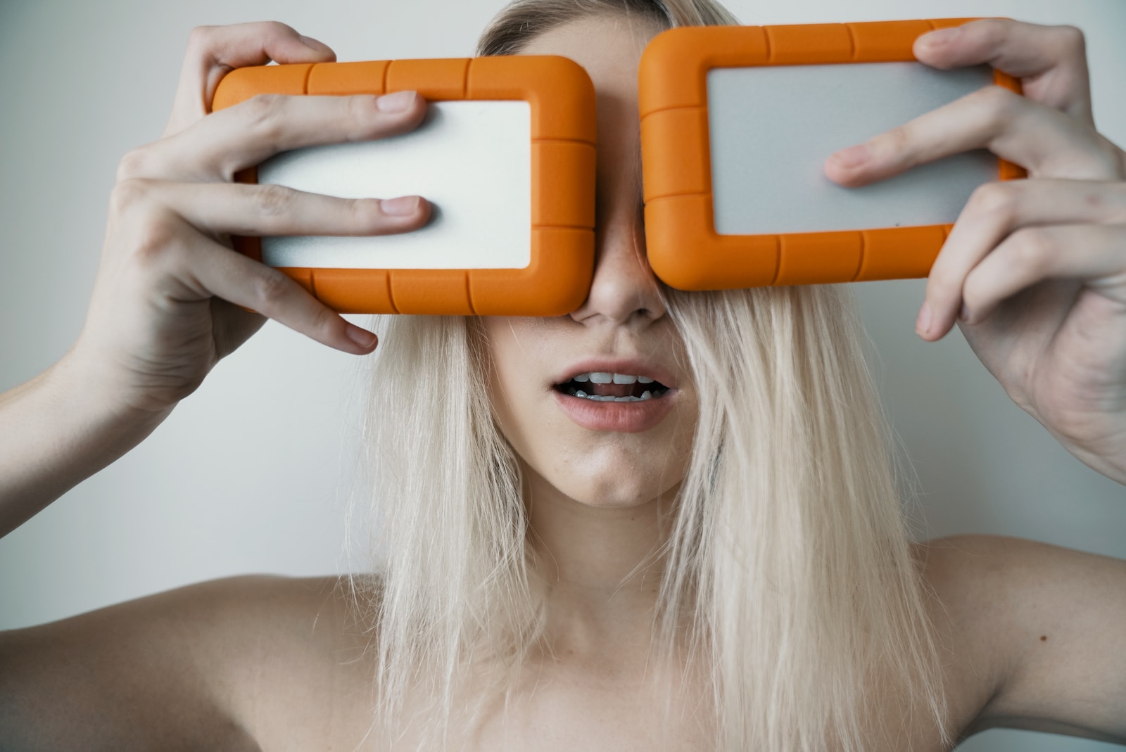 Hard Drives woman holding two white-and-orange plastic cases