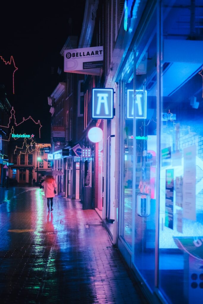 Cinematic Lighting people walking on sidewalk during night time