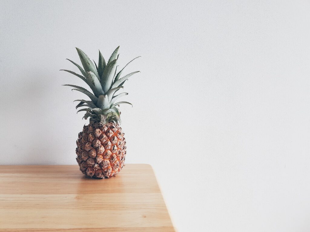 Minimalist Photography pineapple on beige wooden furniture