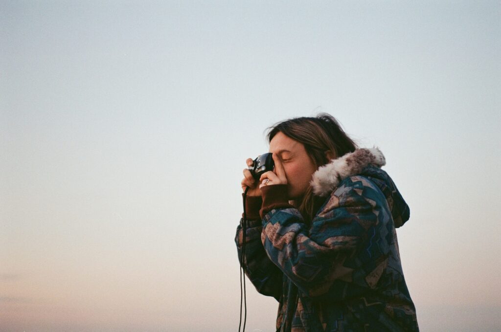 Point and Shoot Camera - a woman taking a picture with a camera