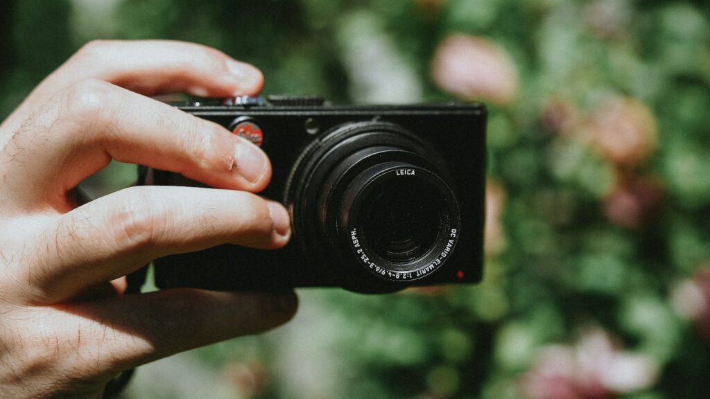 Compact System Camera black Leica M6 camera person holding black camera lens