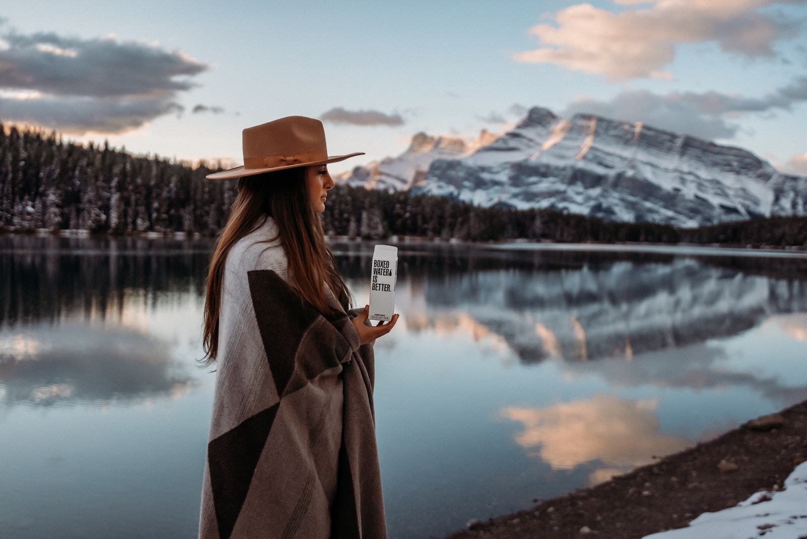 Changing Background in Photoshop woman in brown coat wearing brown hat standing near lake during daytime