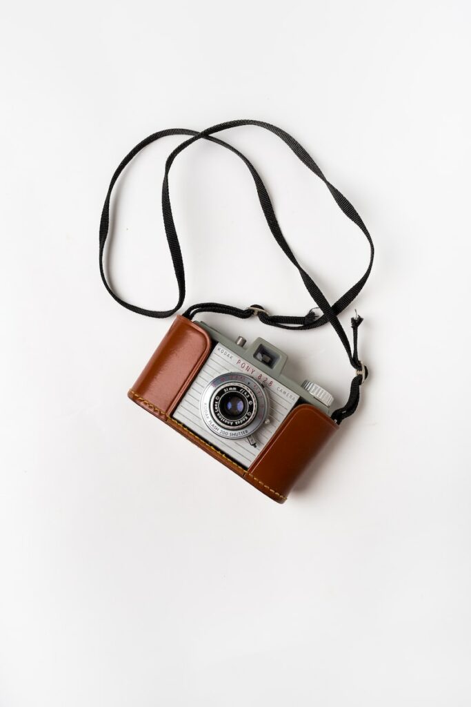 Subminiature Cameras brown and gray SLR camera on white surface