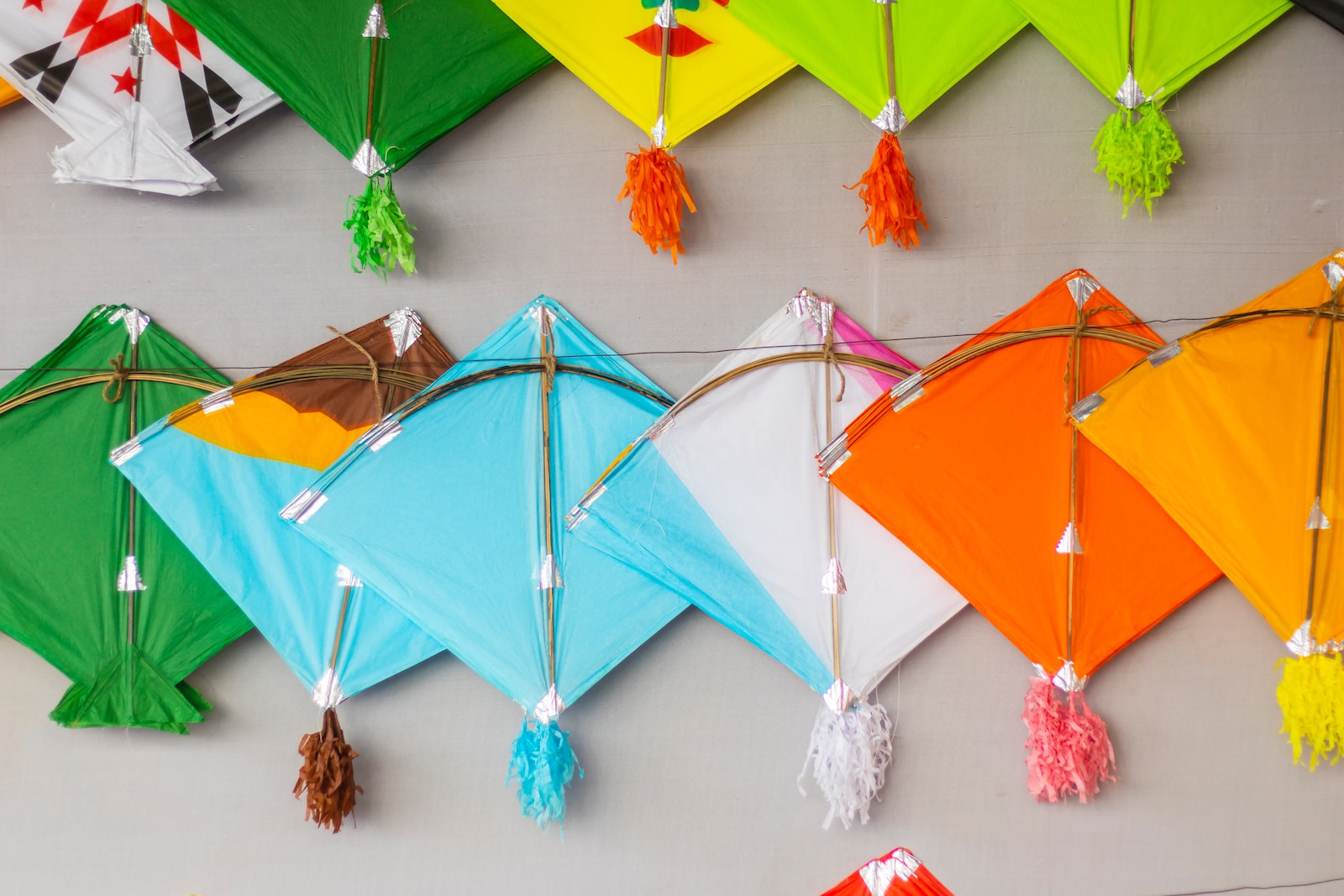 a group of colorful kites hanging on a wall