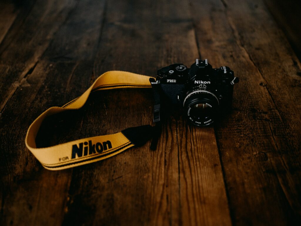 Nikon black nikon dslr camera on brown wooden table