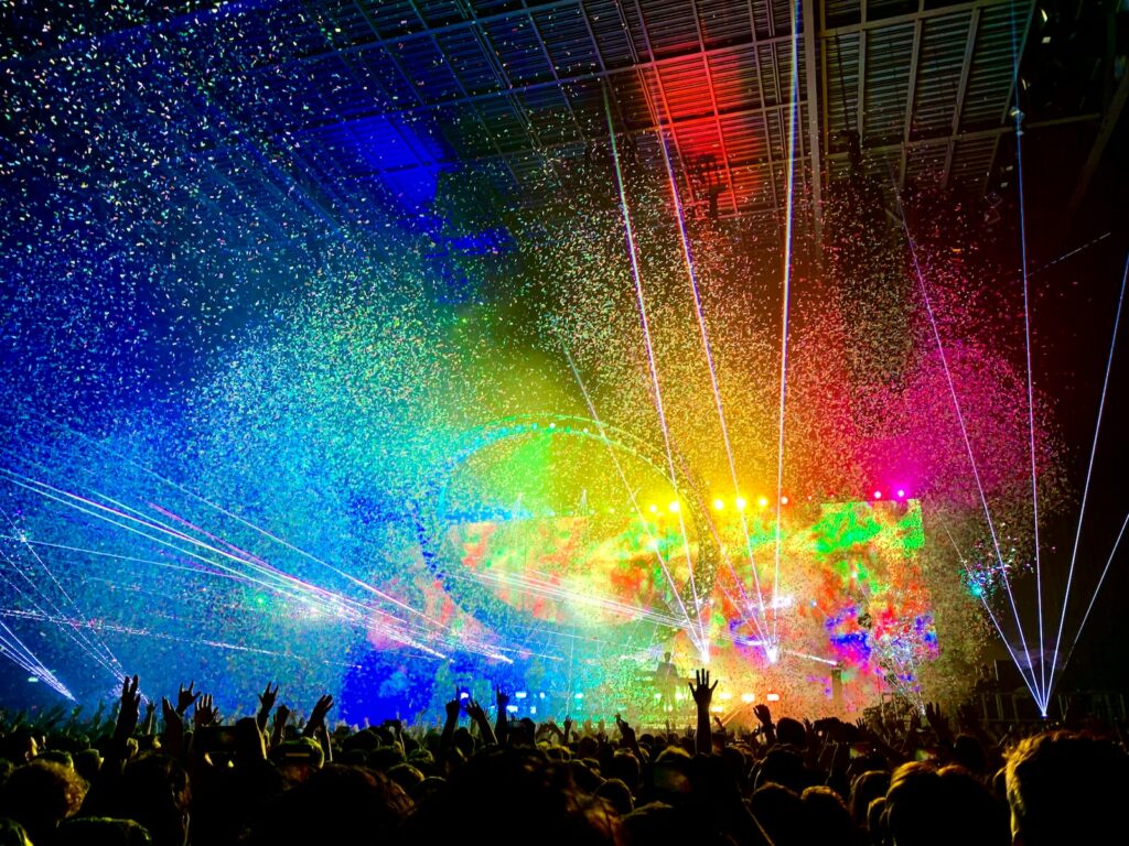 people watching concert with multicolored stage light display