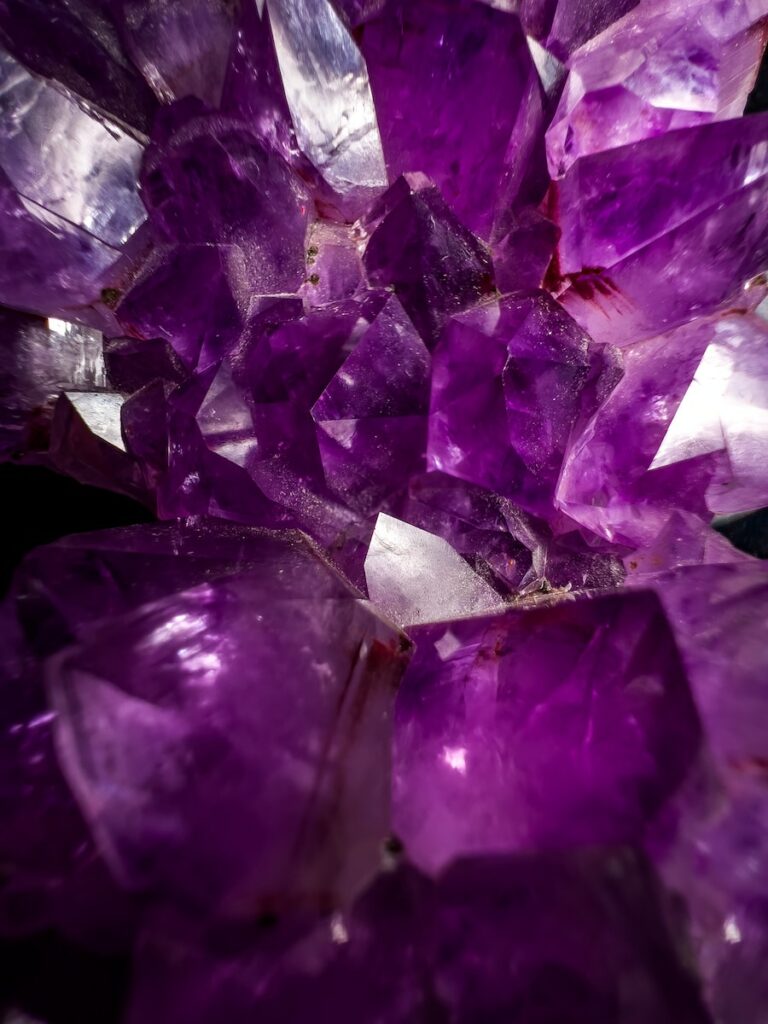 Gemstone Photography a bunch of purple crystals sitting on top of a table