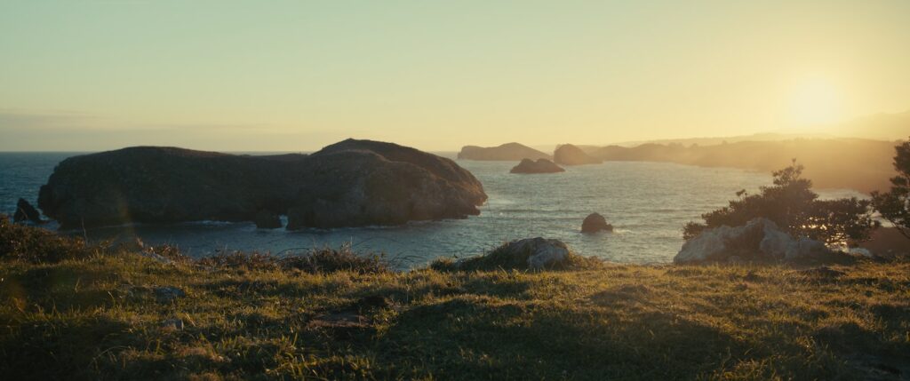 Panoramic Film Camera the sun is setting over a body of water