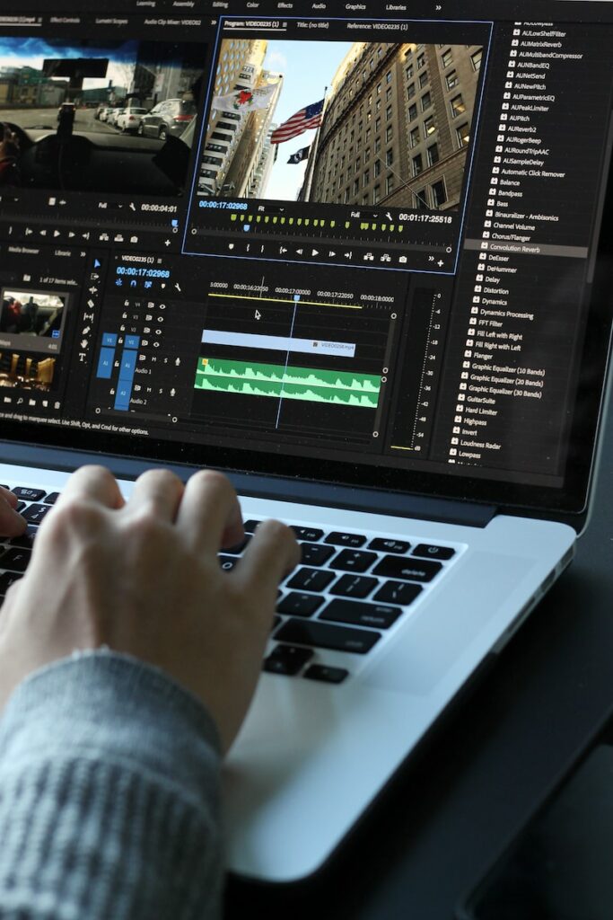 Sound editing person using MacBook pro turned on