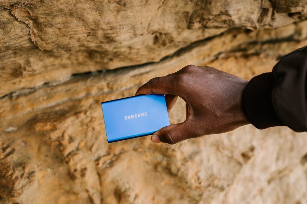 Portable SSD person holding blue and white box