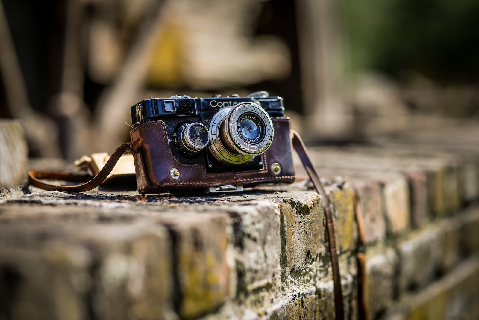 Rangefinder black SLR camera on brown brick surface