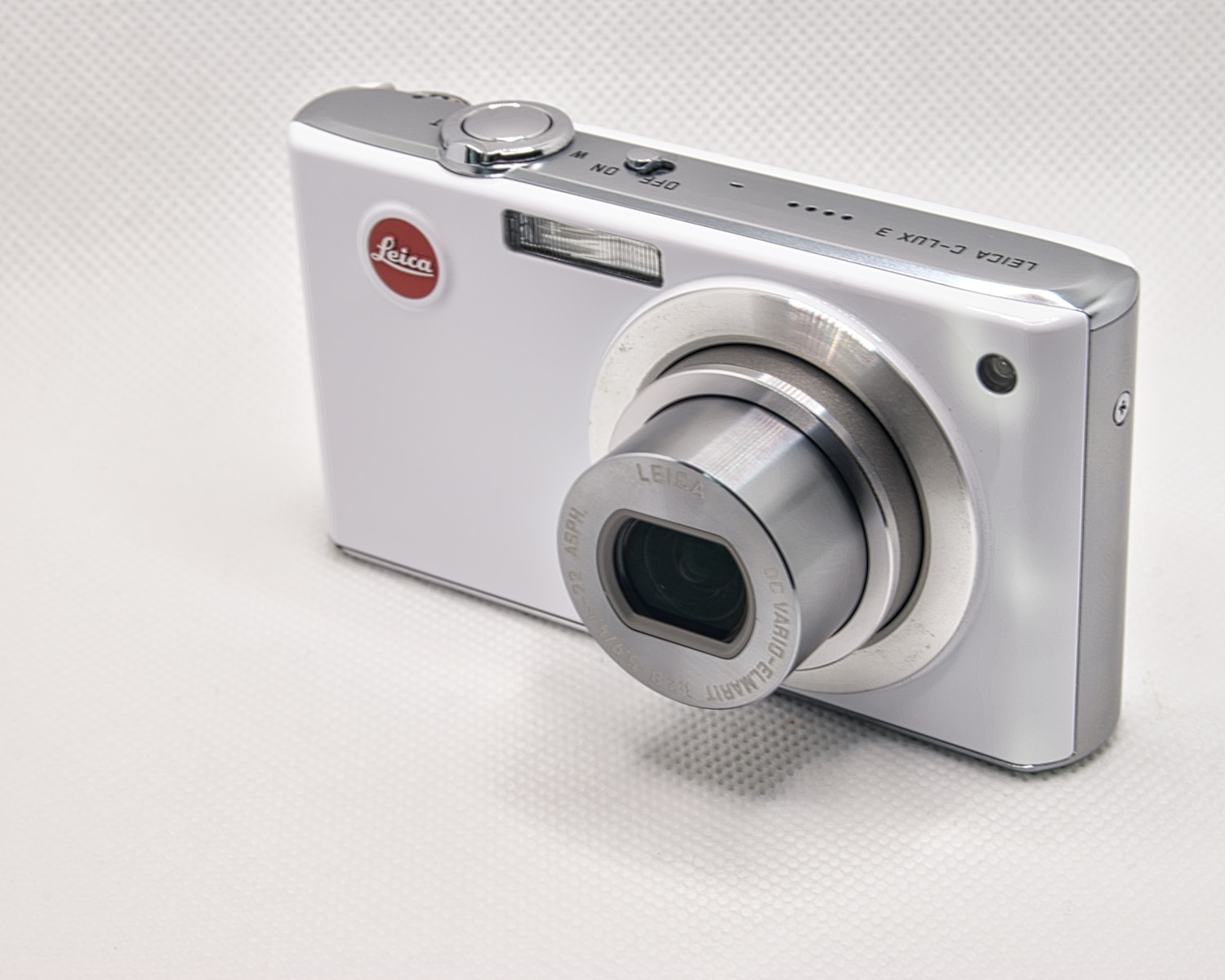 a white camera with a black lens