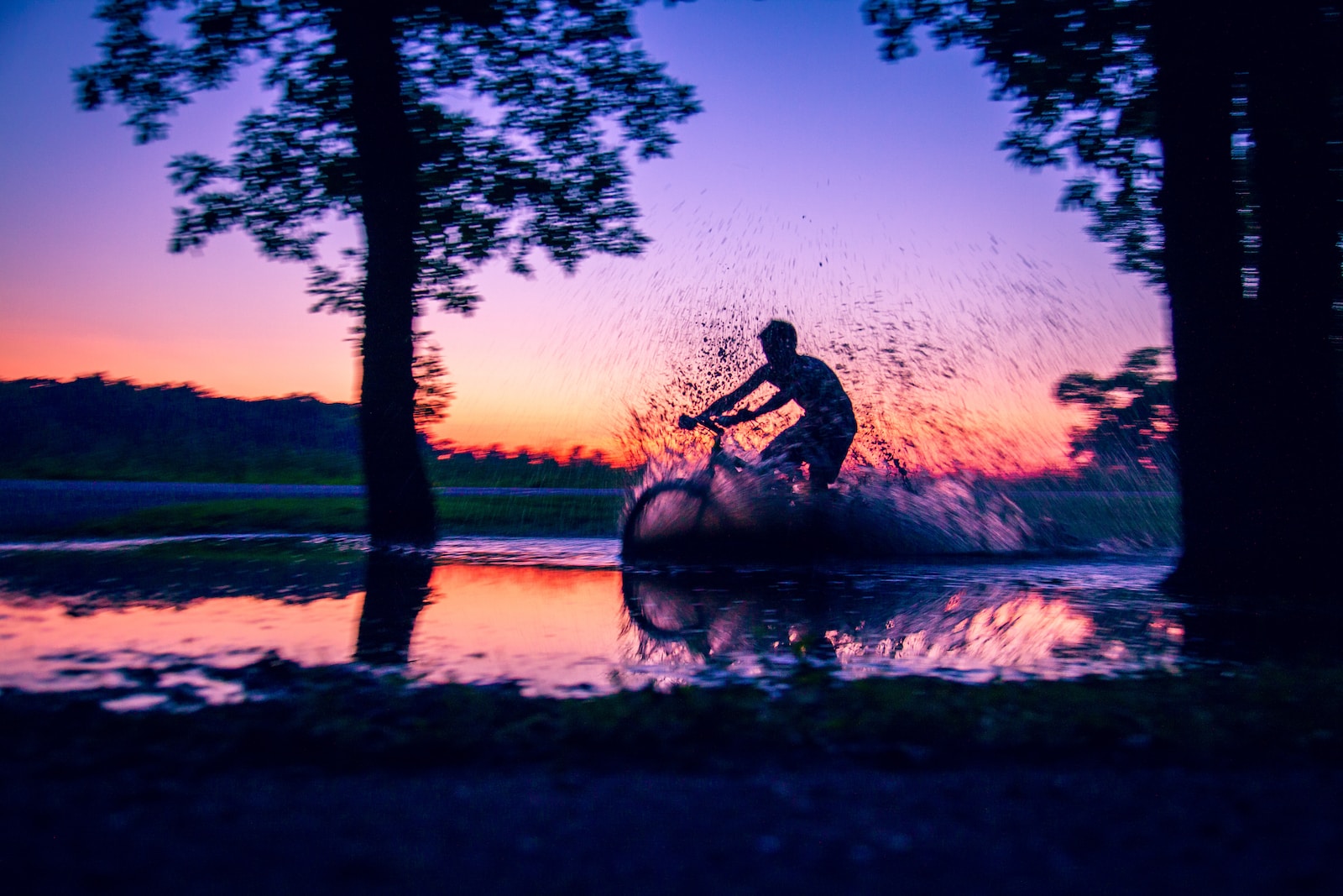 Action Photo silhouette photo of man riding bicycle