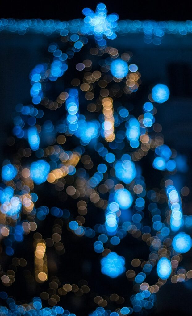 bokeh photo of a blue christmas tree